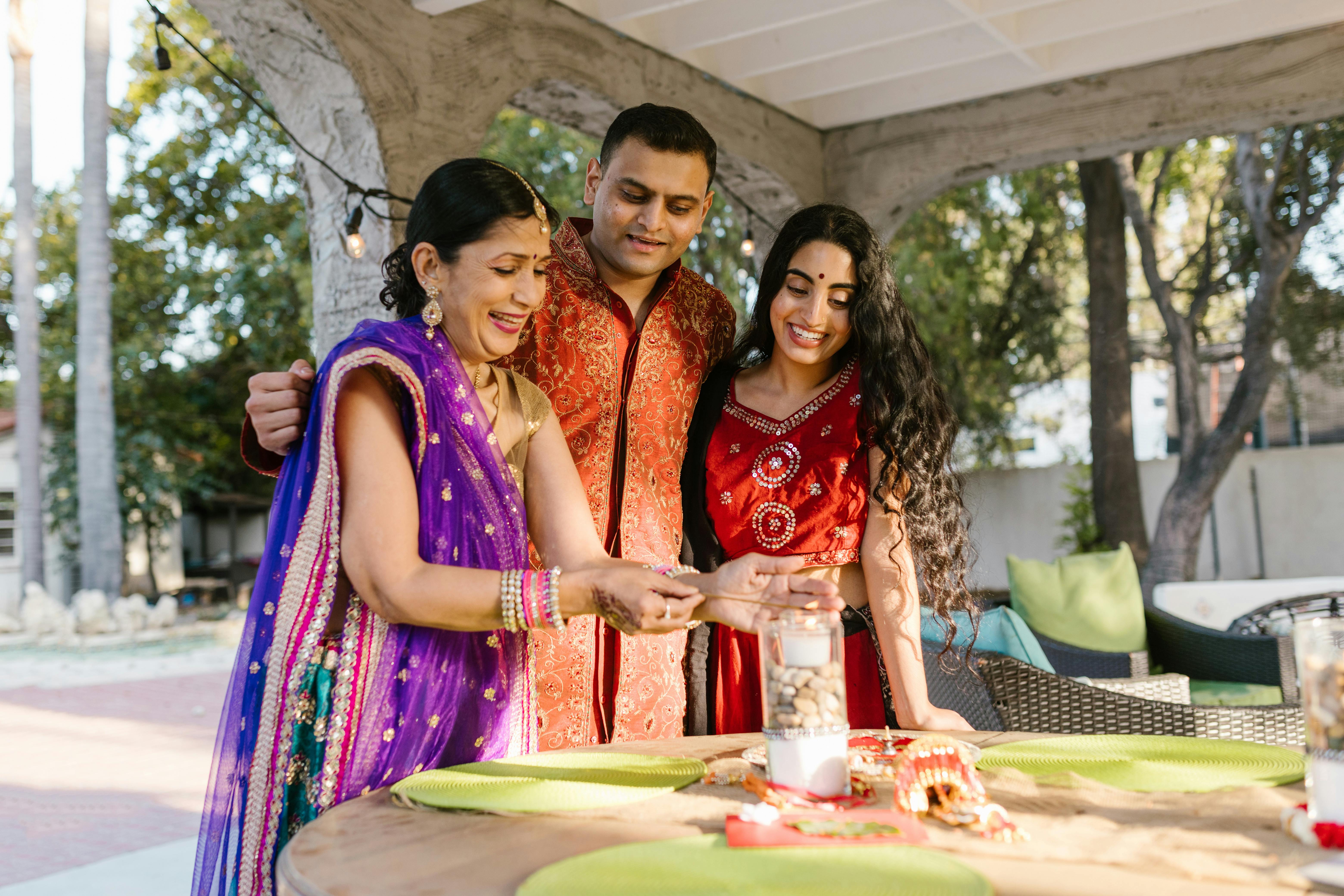 Family gathered around an outdoor table performing a traditional ritual