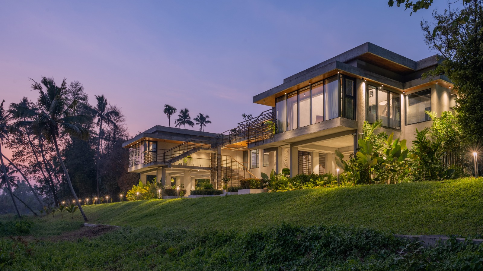 Sovnear estate at sunset viewed from the hillside with tropical gardens
